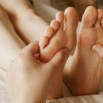 Closeup shot masseur massaging female s feet 150x150