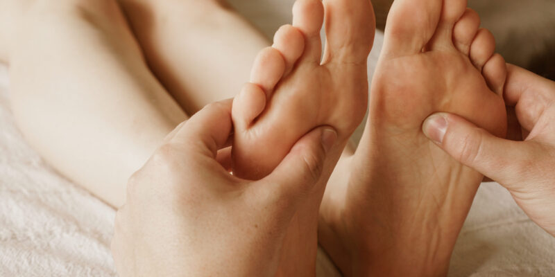 Closeup shot of masseur massaging a female's feet A closeup shot of masseur massaging a female's feet