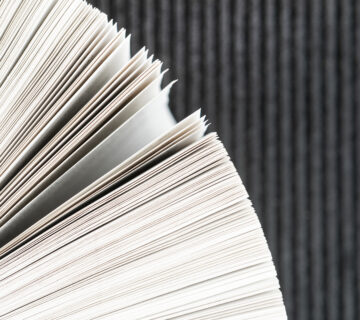 Close up book pages with black background 360x320